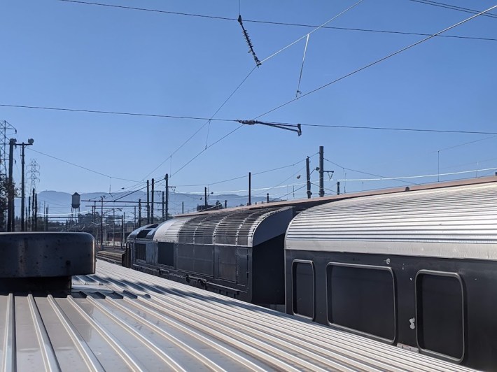 A double-decker Amtrak train, right, running under Catrain overhead wire where the railroads share tracks in San Jose. Photo: Streetsblog/Rudick