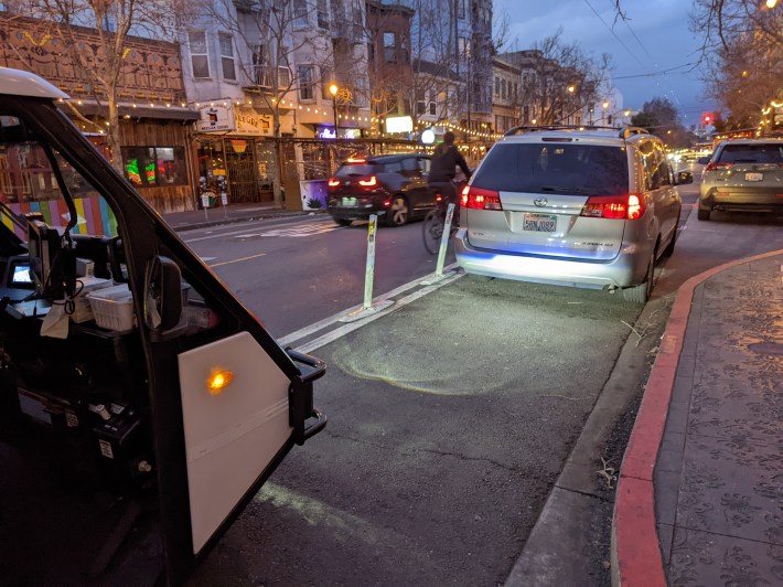 An SFMTA PCO tries to get a scofflaw motorist to get out of the bike lane during Tuesday's "just a minute" protest. Photo: Streetsblog/Rudick