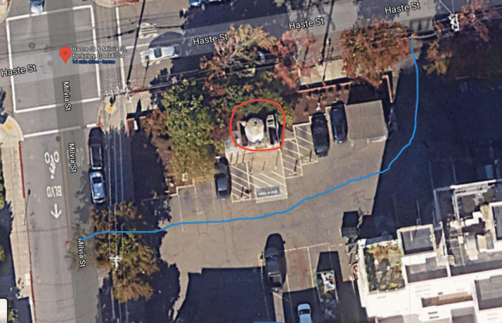 An aerial view of the parking lot. The O2 tank is circled in red. The blue represents the route through the parking lot between Milvia and Haste