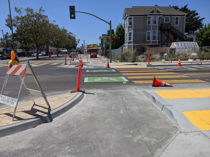 POV of a cyclist of the under-construction protected intersection at 27th.