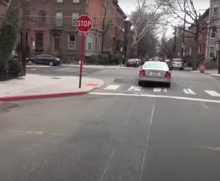 A curb extension in Hoboken. Note the position of the stop sign pole, making it nearly impossible to park on it. Still from Streetsfilm.