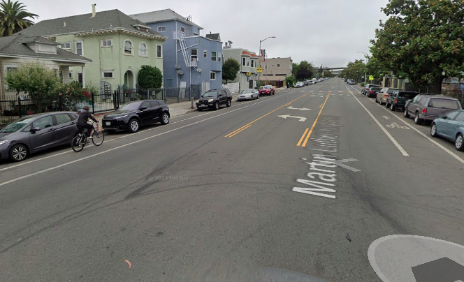 MLK. A cyclist was killed about where this cyclist was riding. It got a lane reduction, but new, unprotected bike lanes. Image: Google Maps