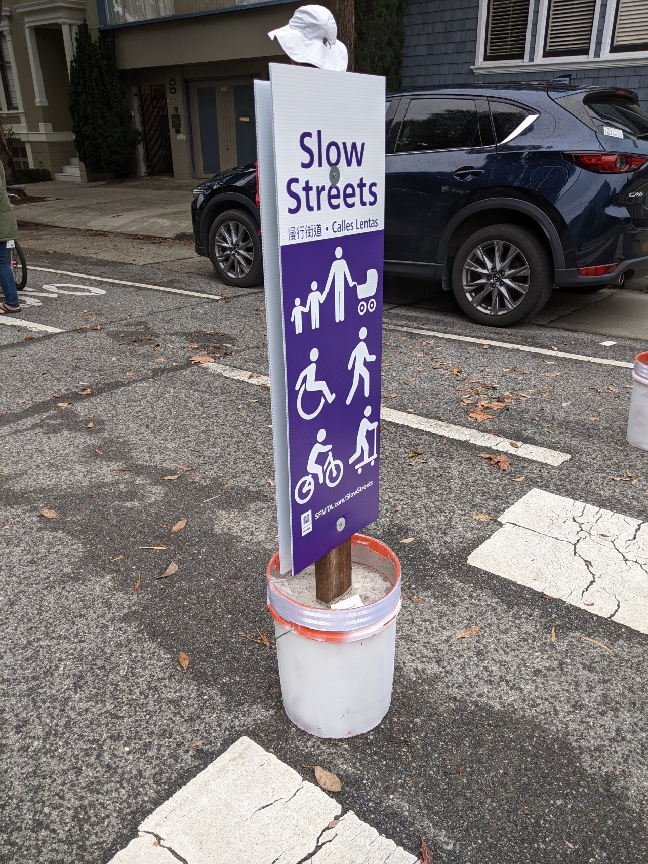 An SFMTA Slow Streets sign embedded in a bucket of concrete. Photo: Streetsblog/Rudick
