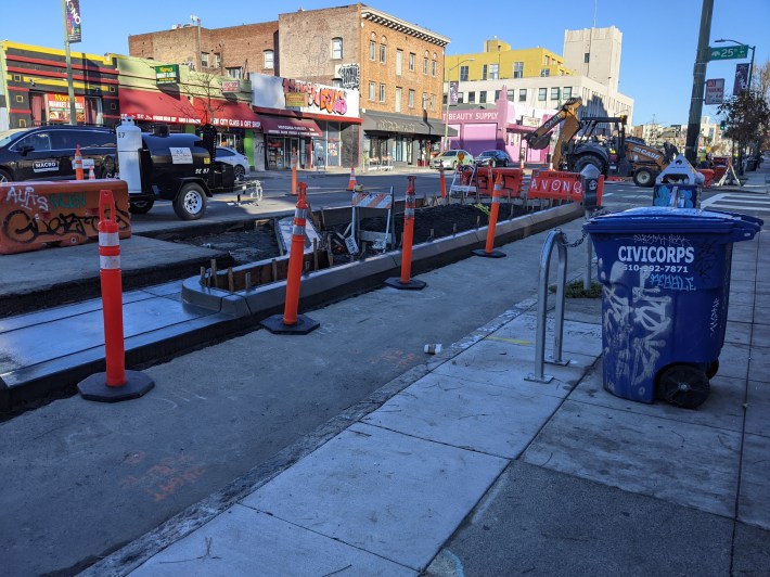 Note the big orange crash barrier, placed where the curb should extend to--but doesn't.