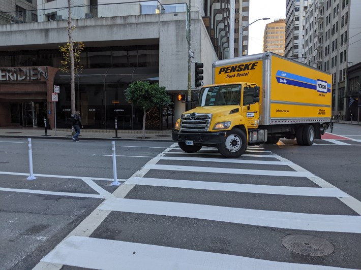 What happens when the driver of a vehicle this size or bigger crosses into the bike space while making a turn?