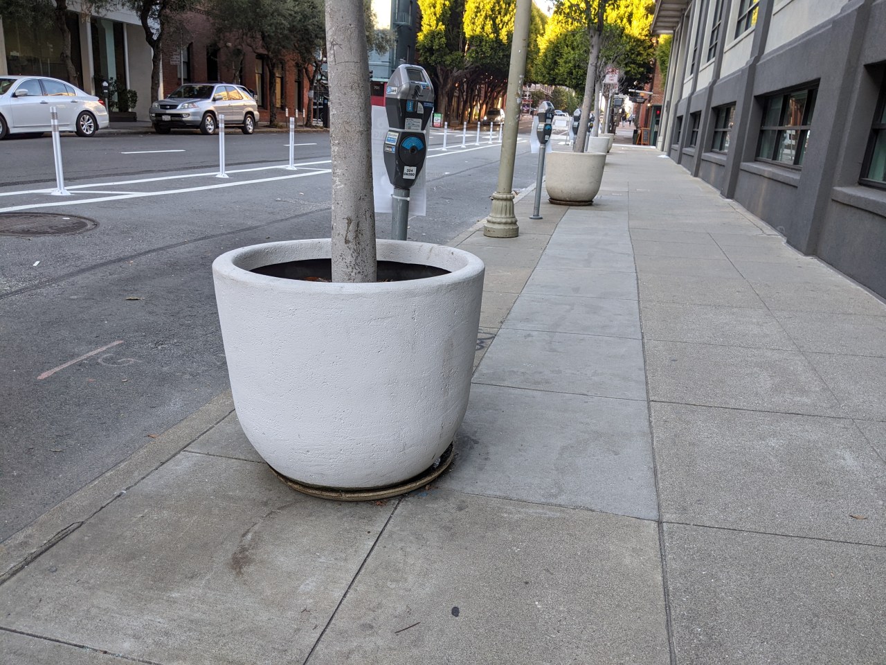 Why would SFMTA put protective planters on the wrong side of the bike lane?