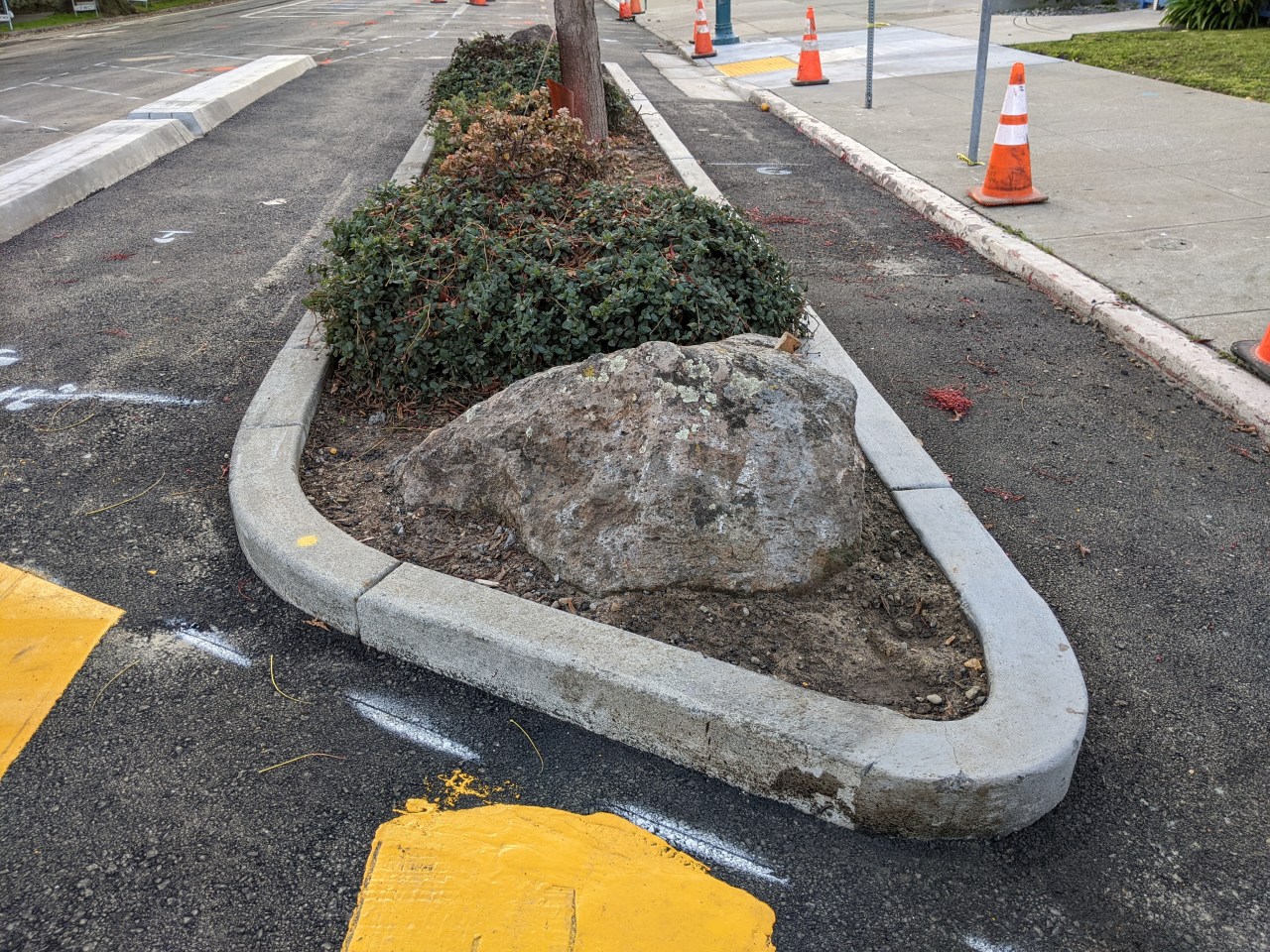 A repurposed bio-swell now integrated into a protected intersection. Photos: Streetsblog/Rudick