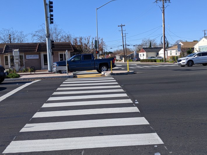 A minimal pedestrian refuge island is an improvement, fair enough.