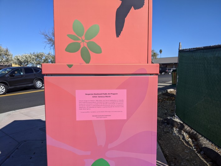 Oh wow! You can look at the painting on this utility box while listening to the roar of traffic while you struggle to get around