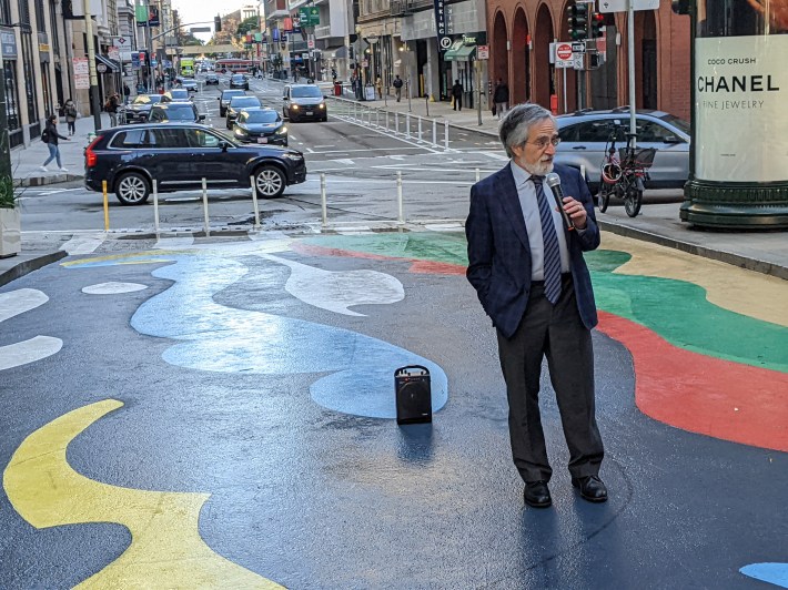 Supervisors Peskin at the Market Street end of the new bike lane, seen behind him over his right shoulder.