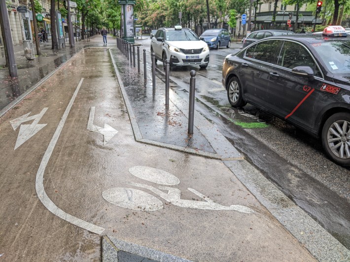 Steel bollards in Paris keep people from parking on the sidewalk or the bike lane