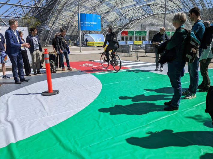 A cyclist going through the corner of a protected intersection.