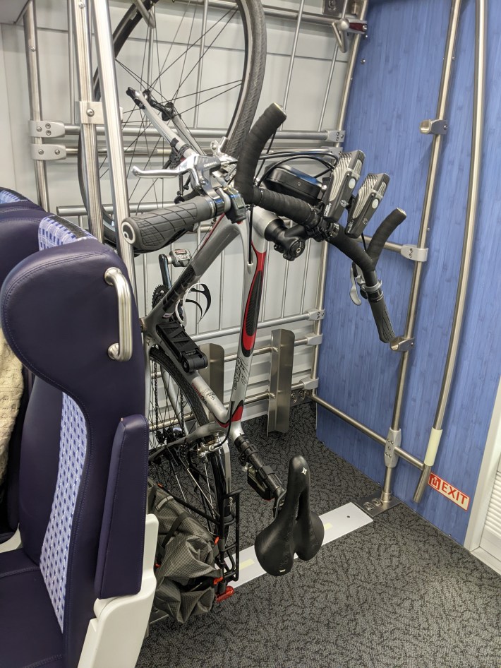 The train stopped short and my bike fell off. I moved it to the farthest hook on the right, so the wall stopped it from falling off when the train braked.